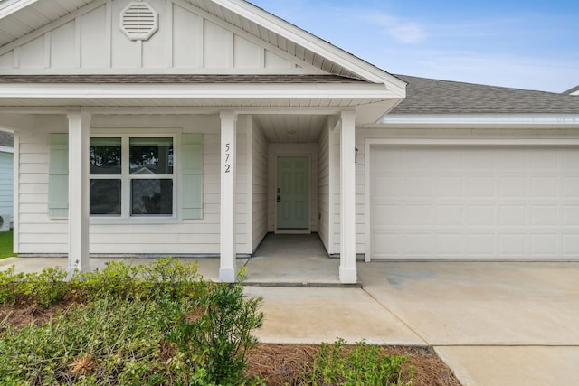 view of front of property featuring covered porch and a garage