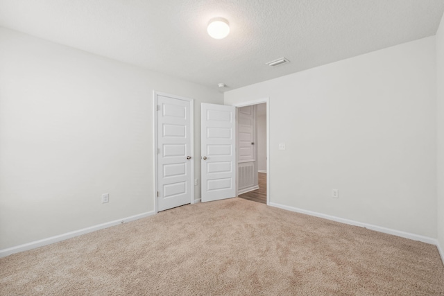 interior space with carpet flooring and a textured ceiling