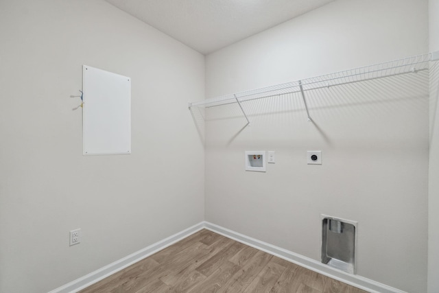 clothes washing area with washer hookup, electric dryer hookup, and light hardwood / wood-style floors