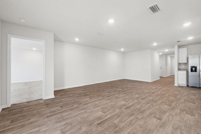 unfurnished living room with light wood-type flooring