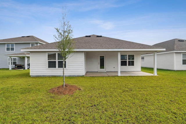 back of property featuring a patio area and a yard