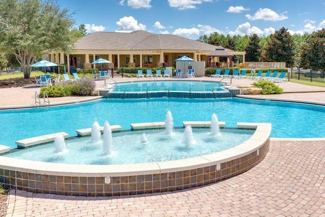 view of swimming pool with pool water feature