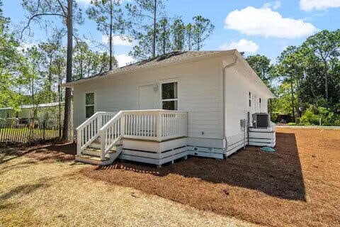 back of house with a deck