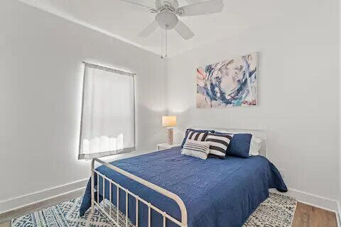 bedroom with ceiling fan and hardwood / wood-style floors