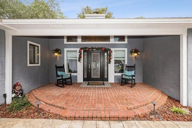 doorway to property with a porch