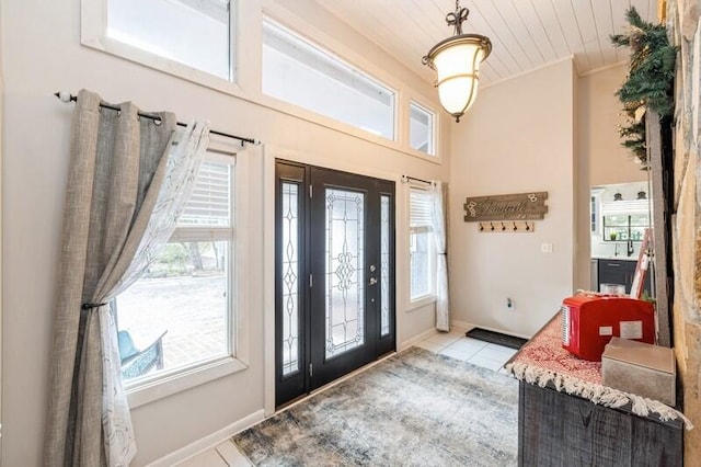 tiled entrance foyer featuring wooden ceiling