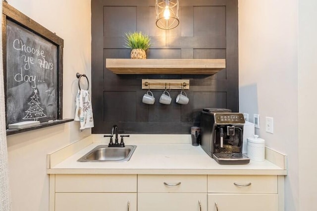 bar featuring cream cabinetry and sink