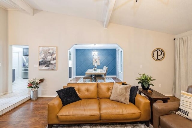 living room with lofted ceiling with beams and hardwood / wood-style flooring