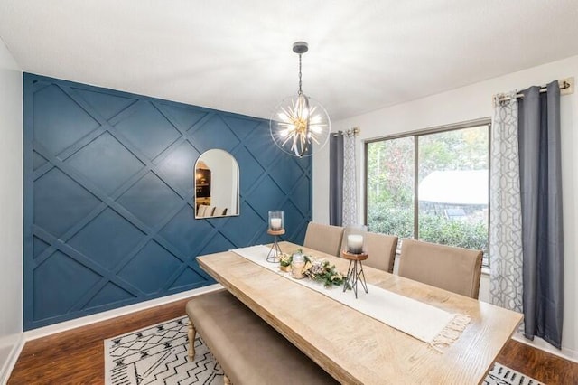 dining space featuring dark hardwood / wood-style floors and a notable chandelier