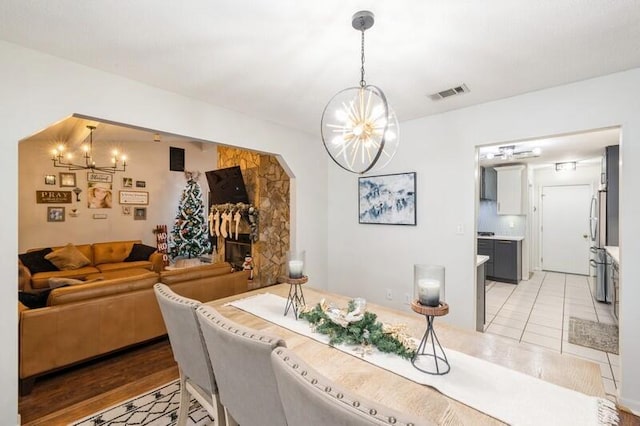 tiled dining space featuring an inviting chandelier