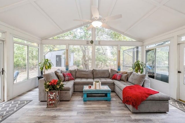 sunroom / solarium with ceiling fan and lofted ceiling