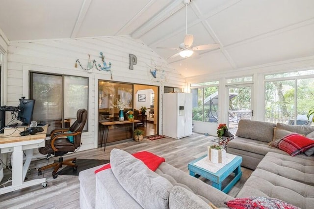 sunroom / solarium featuring ceiling fan and vaulted ceiling