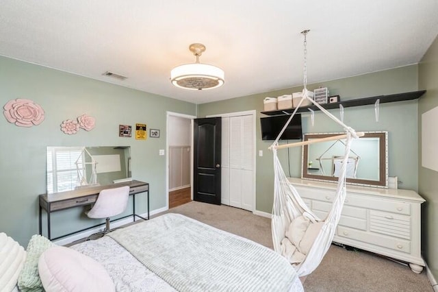 bedroom featuring light carpet and a closet