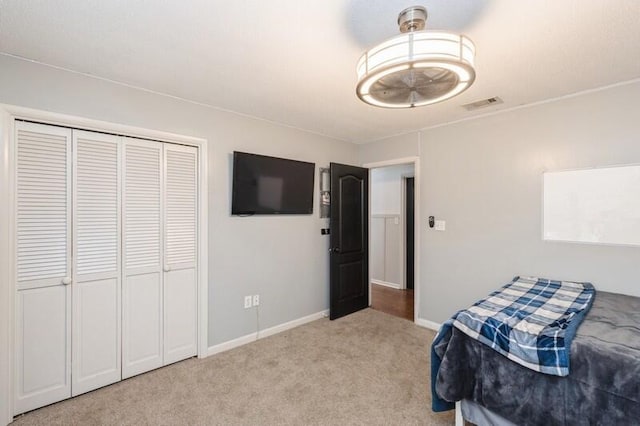 bedroom with light carpet and a closet