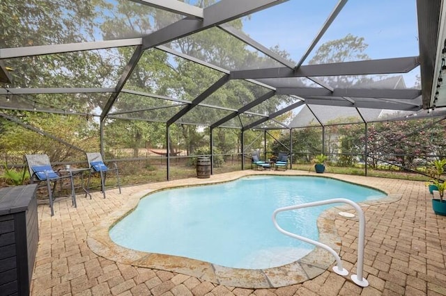 view of swimming pool with a patio and glass enclosure