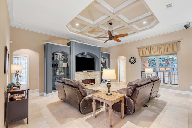 tiled living room with coffered ceiling, plenty of natural light, crown molding, and ceiling fan