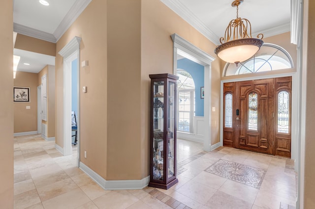 tiled entryway featuring ornamental molding