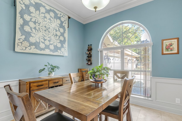 dining area featuring a healthy amount of sunlight, ornamental molding, and light tile patterned floors