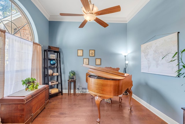 misc room with hardwood / wood-style floors, ceiling fan, and crown molding