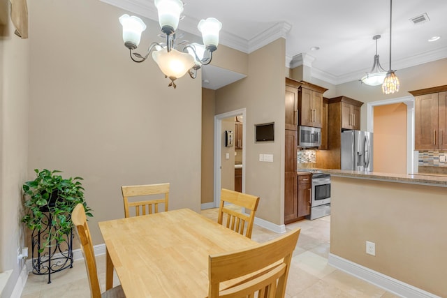 tiled dining area featuring crown molding and an inviting chandelier