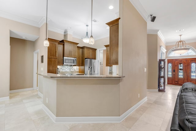 kitchen with pendant lighting, decorative backsplash, kitchen peninsula, and stainless steel appliances