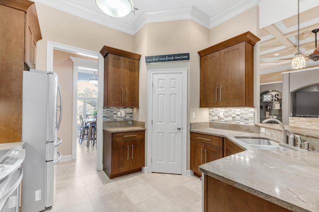 kitchen with coffered ceiling, decorative light fixtures, white appliances, and tasteful backsplash