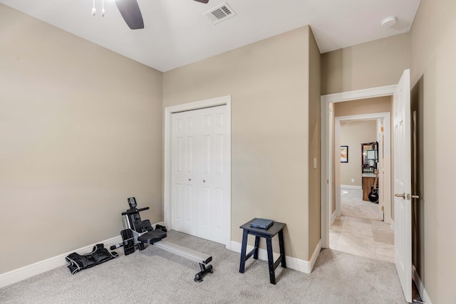 workout room with light carpet and ceiling fan