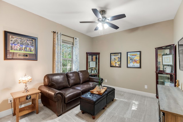 carpeted living room featuring ceiling fan