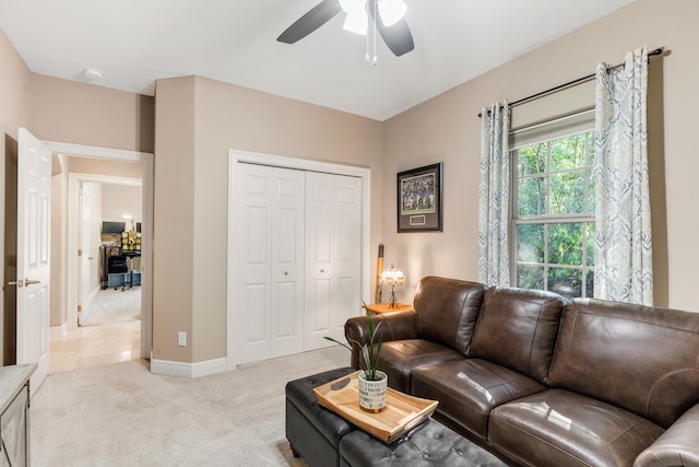 living room featuring light colored carpet and ceiling fan