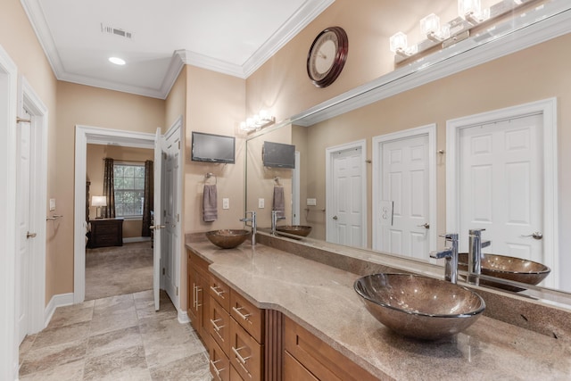 bathroom with crown molding and vanity