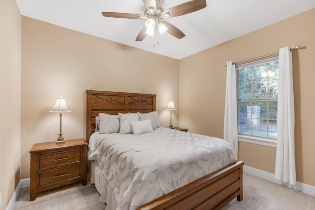 bedroom with light colored carpet and ceiling fan