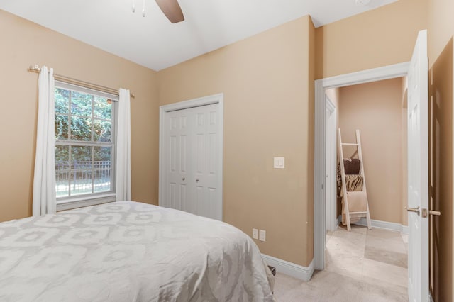 tiled bedroom featuring ceiling fan and a closet