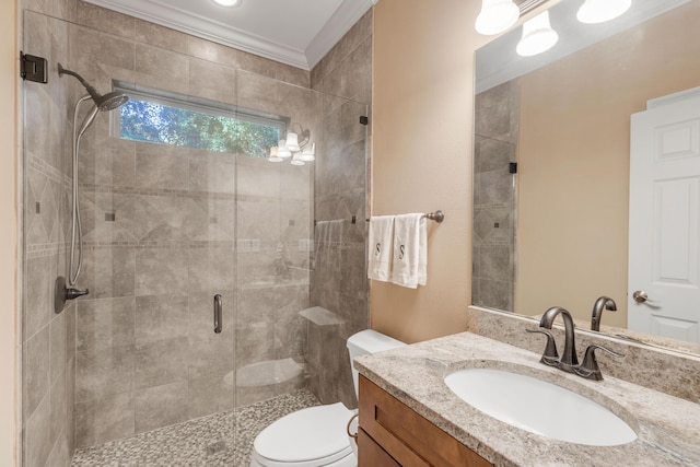 bathroom featuring vanity, toilet, a shower with shower door, and crown molding