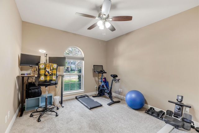 workout room featuring ceiling fan and light colored carpet