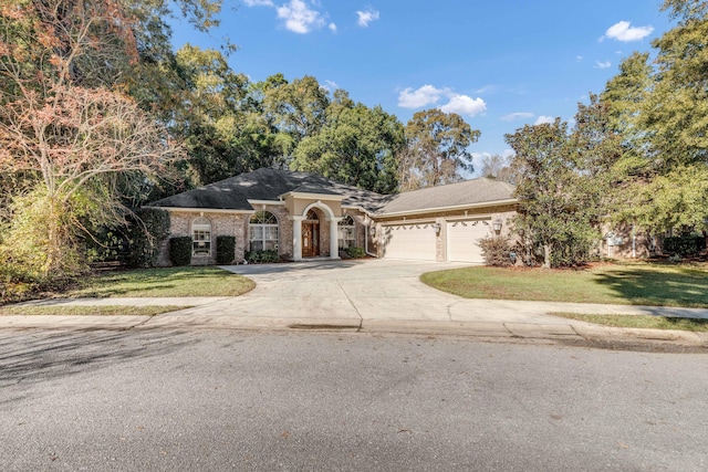 view of front facade with a front yard and a garage