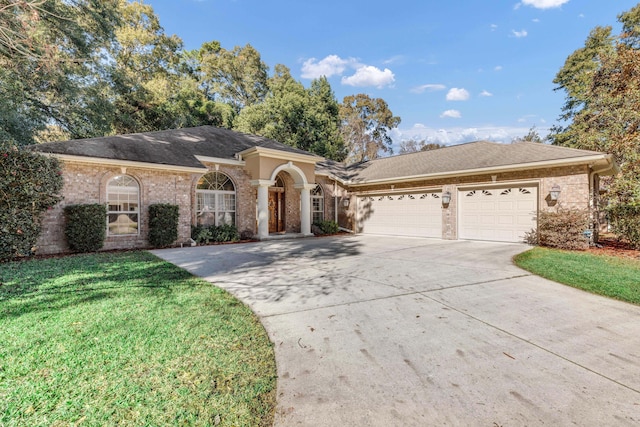 single story home featuring a garage and a front yard