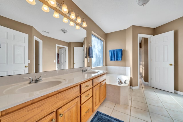 bathroom featuring a bathing tub, a textured ceiling, tile patterned floors, and vanity