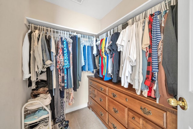 spacious closet featuring light carpet