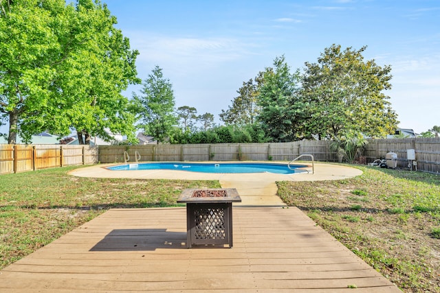 view of swimming pool featuring a deck and a fire pit