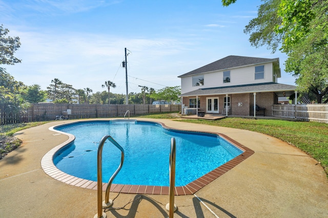 view of pool featuring french doors and a patio area