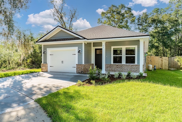 view of front facade featuring a front yard, a garage, and covered porch