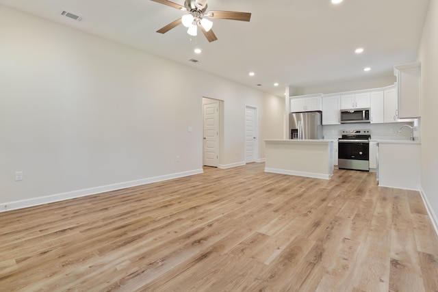 unfurnished living room featuring light wood-type flooring and ceiling fan