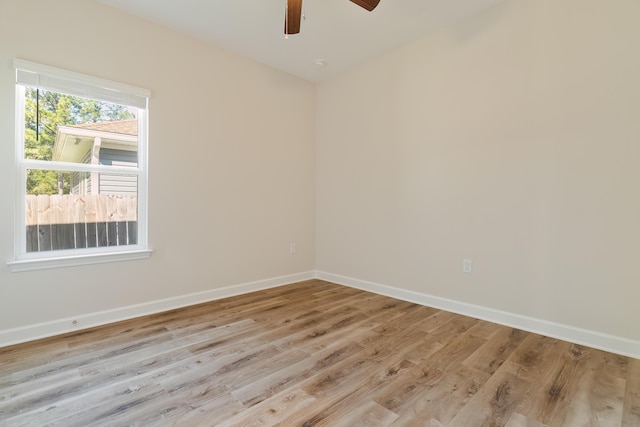 spare room with light wood-type flooring and ceiling fan