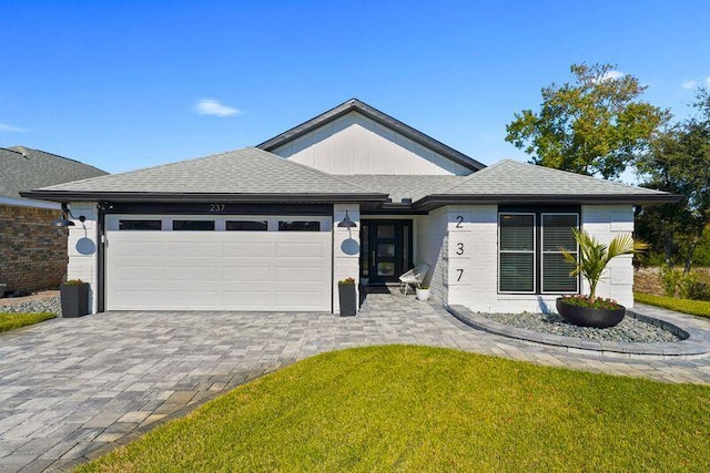237 Sandy Cay Dr, Miramar Beach, FL 32550 - single story home with an attached garage, decorative driveway, a shingled roof, and brick siding