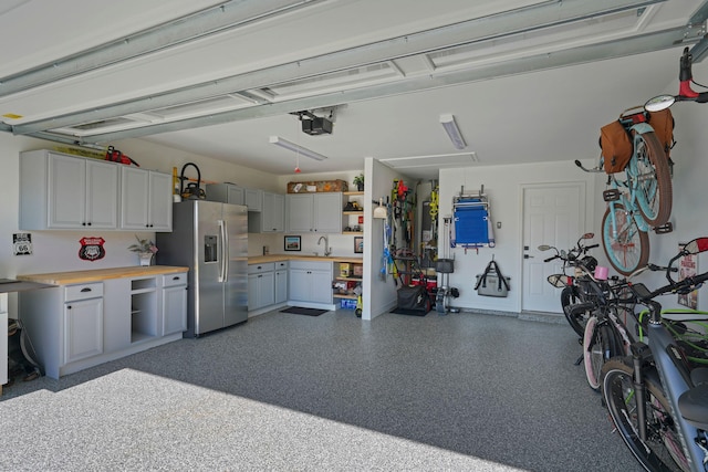 237 Sandy Cay Dr, Miramar Beach, FL 32550 - garage featuring stainless steel fridge and a sink