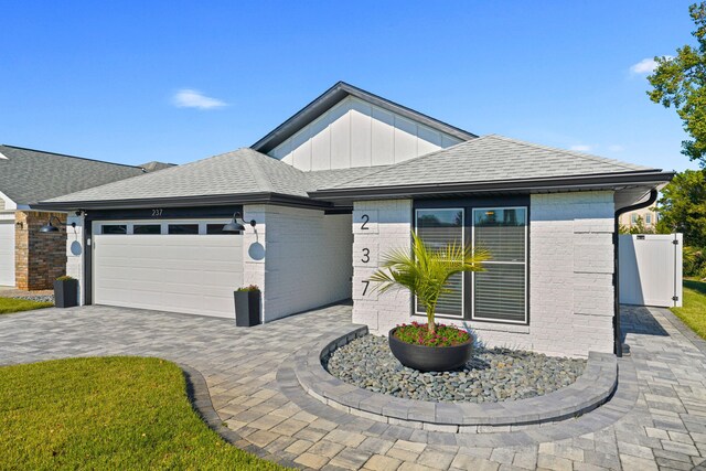 237 Sandy Cay Dr, Miramar Beach, FL 32550 - ranch-style home with a garage, brick siding, decorative driveway, and a shingled roof