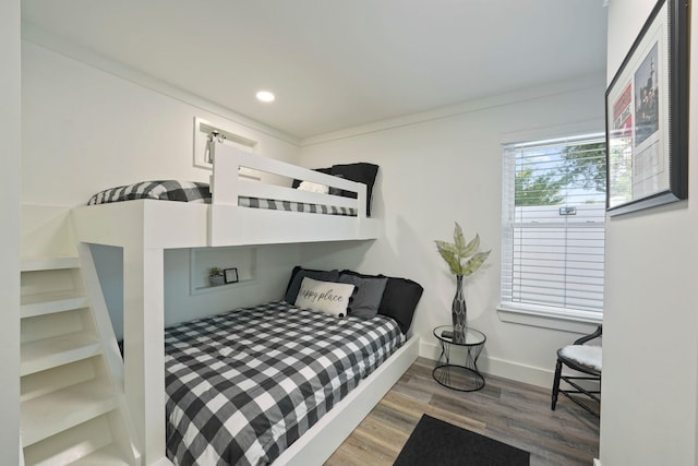 bedroom featuring hardwood / wood-style flooring and ornamental molding