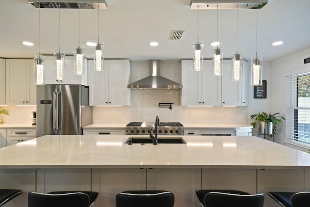 237 Sandy Cay Dr, Miramar Beach, FL 32550 - kitchen featuring wall chimney range hood, freestanding refrigerator, light countertops, backsplash, and recessed lighting