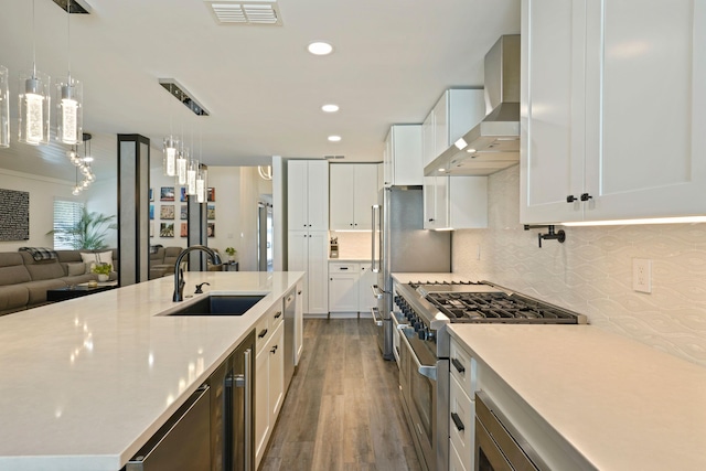 237 Sandy Cay Dr, Miramar Beach, FL 32550 - kitchen with a sink, wall chimney range hood, high end stainless steel range oven, dark wood-style flooring, and backsplash