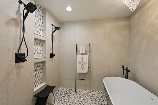 bathroom featuring plus walk in shower, tile walls, and a notable chandelier